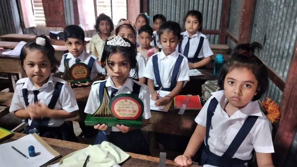 Hazi Fazlul Haque Academy students with school awards in their classroom